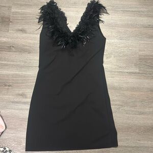 Italian black mini dress with authentic feathers around collar size small.